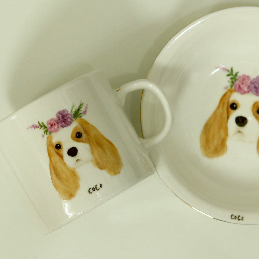 Mug and coaster set with a dog illustration and floral design on a white background
